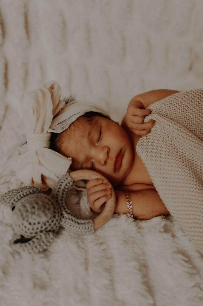 baby holding toy in photography studio in Queensbury, NY