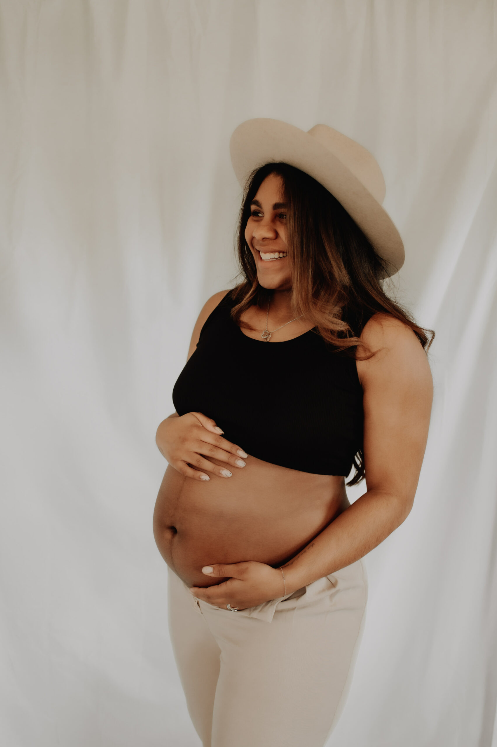 Boho pregnancy photo with draped backdrop near Glens Falls, NY